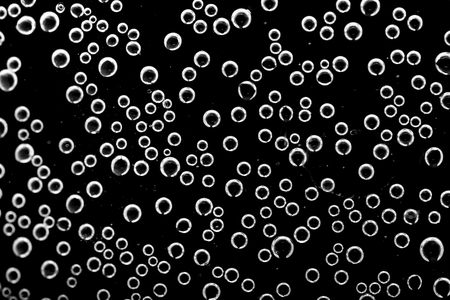 Air bubbles in the water on a black backgroundの写真素材
