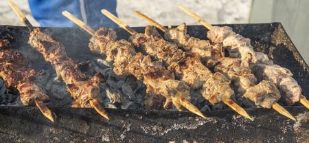 Skewers are fried on the street, the meat on the sticks.の写真素材