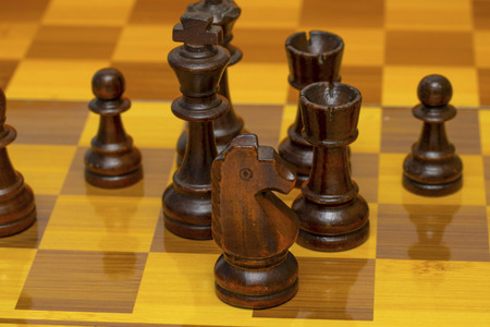 Chess pieces on a chessboard, wooden pieces.