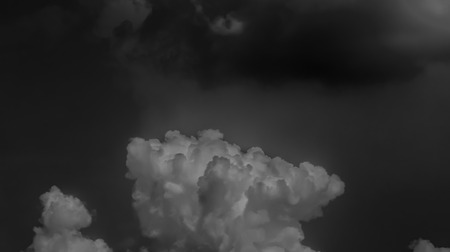 White clouds on a dark sky, monochrome.