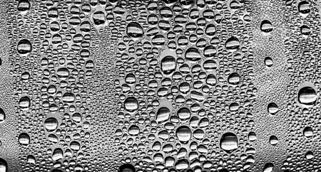 Raindrops on the glass, black-white background, fashion glass texture.の写真素材