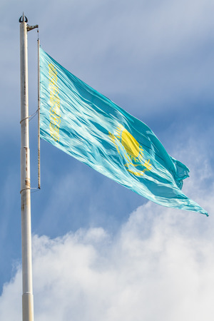 Flag of the Republic of Kazakhstan on a background of blue sky, wind sky clouds.の写真素材