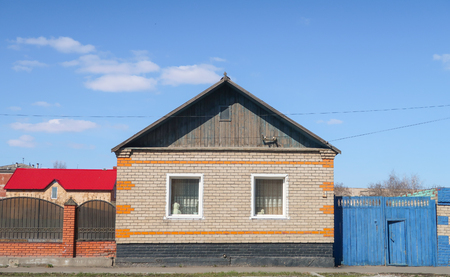 Petropavlovsk, Kazakhstan - May 2, 2019: House with a fence against the blue sky, spring landscape.のeditorial素材