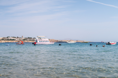 Sharm el-Sheikh, Egypt - November 11, 2017: Naama Bay sea beach in Sharm el-Sheikh, Egypt. People bathe, rest. Boats are sailing in the sea.のeditorial素材