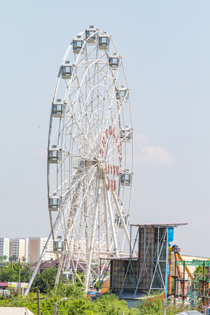 Shymkent Kazakhstan April 17, 2019: A review wheel in the racetrack area. Recreation Park. Nature summer blue sky.のeditorial素材