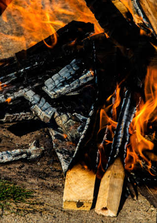 Abstract background, bright flame of fire, burnt pieces of wood.の写真素材
