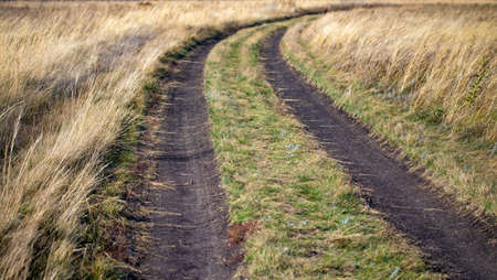 Mud blurred road, autumn field.