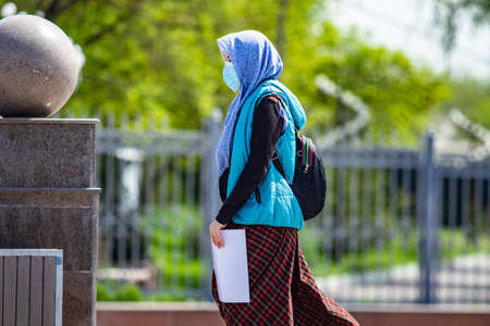 Muslim girl in a scarf goes to the mosqueの写真素材