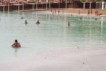 Dead Sea, Israel - November 14, 2017: Caucasian man floating in the waters of the Dead Sea in Israel. Beach vacation.の写真素材