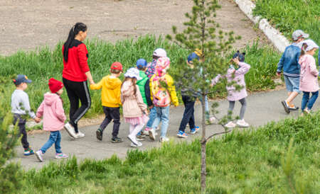 Petropavlovsk, Kazakhstan - May 31, 2019: Children walk down the street in a summer park.のeditorial素材