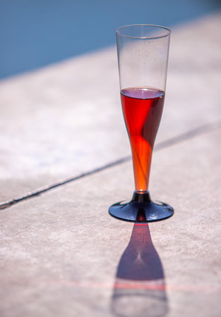A glass of red wine on the background of nature on a sunny day.の写真素材