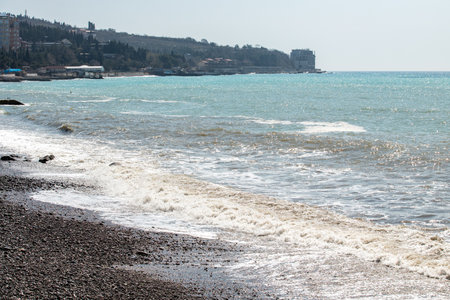 foamy coastal sea wave of a pebble beachの写真素材
