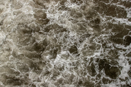 Strong foamy sea wave on the shore.の写真素材