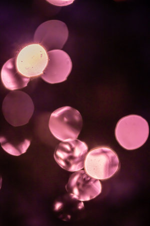Bokeh abstraction, round bright multi-colored lights out of focus, holiday background.