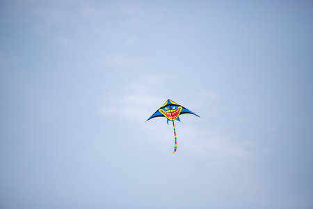 Nice kite flying colors against the blue sky.の写真素材