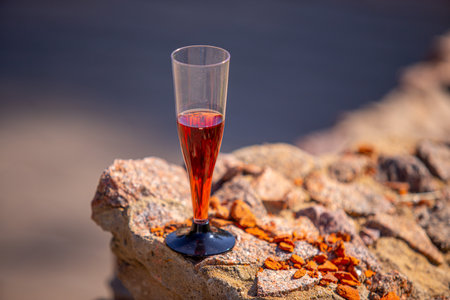 A glass of red wine on the background of nature on a sunny day.の写真素材