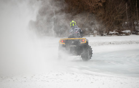 Petropavlovsk, Kazakhstan - 04.02.2023:ATVs on the snowy ice of the lake. In winter, young people ride ATVs on the ice.の写真素材