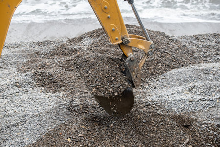 The excavator bucket extracts the pebbles.の写真素材