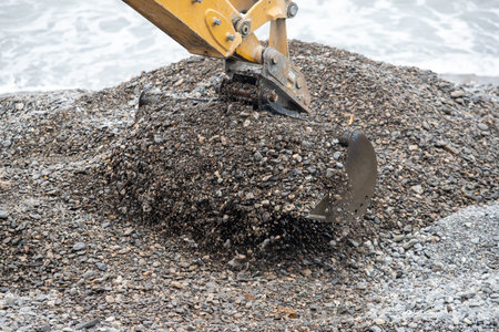 The excavator bucket extracts the pebbles.の写真素材