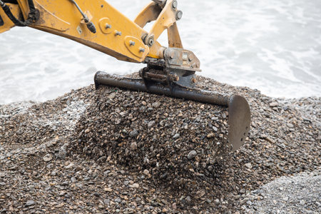 The excavator bucket extracts the pebbles.の写真素材