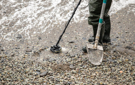 Mine detector on a pebble sea beach.の写真素材
