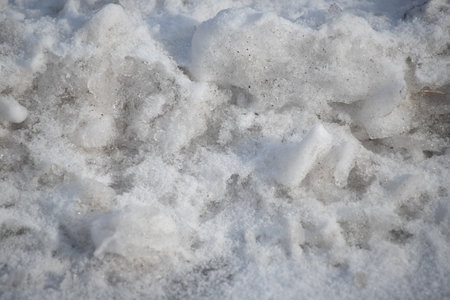 snow covered road with footprintsの写真素材