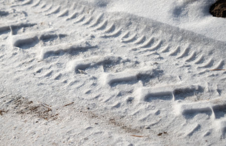 snow covered road with footprintsの写真素材