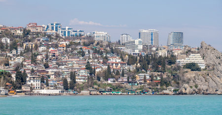 Yalta, Crimea - April 19, 2022: Embankment of the sea, high-rise buildings on the seashore.の写真素材