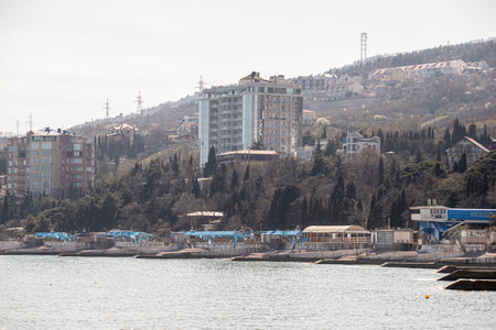 Yalta, Crimea - April 19, 2022: Embankment of the sea, high-rise buildings on the seashore.の写真素材