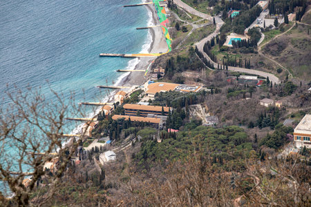 Yalta, Crimea - April 19, 2022: Embankment of the sea, high-rise buildings on the seashore.の写真素材