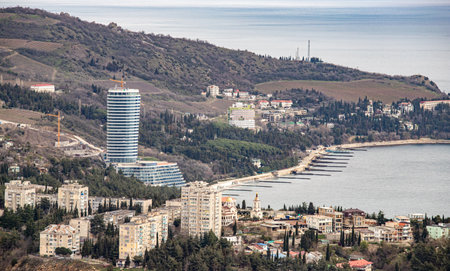 Yalta, Crimea - April 19, 2022: Embankment of the sea, high-rise buildings on the seashore.の写真素材