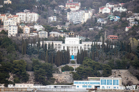 Yalta, Crimea - April 19, 2022: Embankment of the sea, high-rise buildings on the seashore.の写真素材