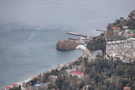 Yalta, Crimea - April 19, 2022: Embankment of the sea, high-rise buildings on the seashore.の写真素材