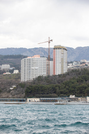 Yalta, Crimea - April 19, 2022: Embankment of the sea, high-rise buildings on the seashore.の写真素材