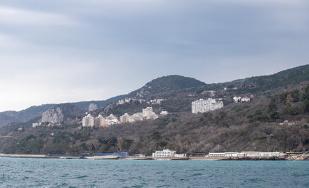 Yalta, Crimea - April 19, 2022: Embankment of the sea, high-rise buildings on the seashore.の写真素材