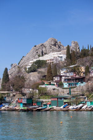Yalta, Crimea - April 19, 2022: Embankment of the sea, high-rise buildings on the seashore.