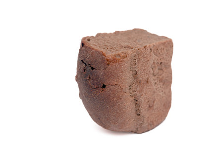 Half a loaf of rye bread on a white background.の写真素材