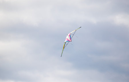 The kite flies against the sky.