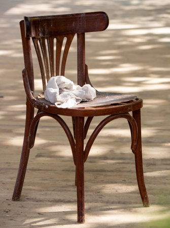an old wooden chair stands on the streetの写真素材