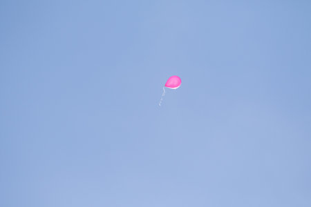rubber balloon high in the blue skyの写真素材