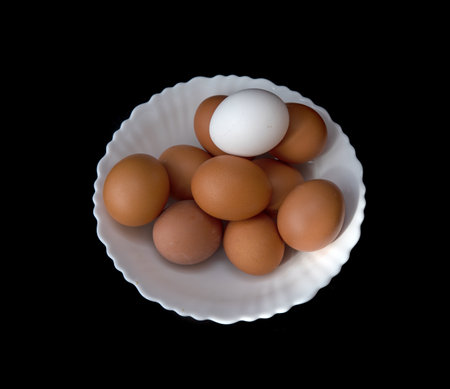 Chicken eggs on a black background.の写真素材