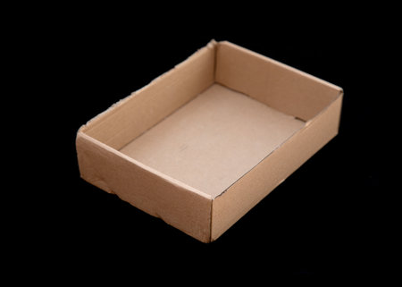 Cardboard box on a black background.