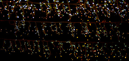 christmas lights on black background, abstract christmas lights on black backgroundの写真素材