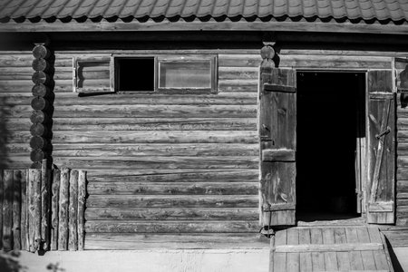 Old gray wooden fence wall of a houseの写真素材