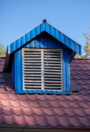 triangular roof of a house against the skyの写真素材