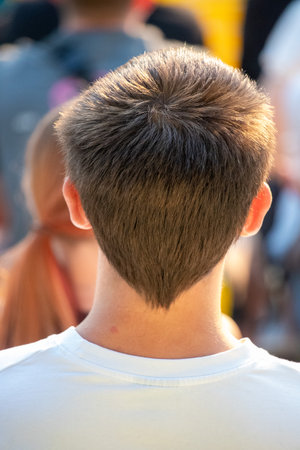 A man with a shaved head and shaved sideburns. He is wearing a white shirtの写真素材