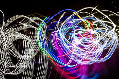The image is a colorful, abstract painting of light trails. The colors are bright and vibrant, creating a sense of energy and movement. The painting seems to be inspired by the idea of motionの写真素材