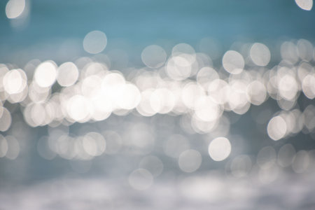 The image is a blurry water shot with many small circles. Scene is calm and serene, as the water appears to be still and peaceful. The idea of the image is to capture the beauty of natureの写真素材