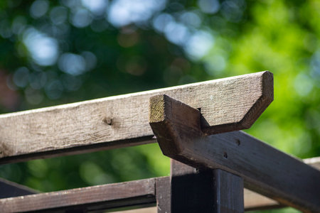 A wooden beam with a wood piece sticking out of it. The beam is brown and the wood piece is whiteの写真素材