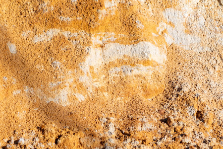 A wall with a lot of dirt and sand on it. The wall is brown and whiteの写真素材